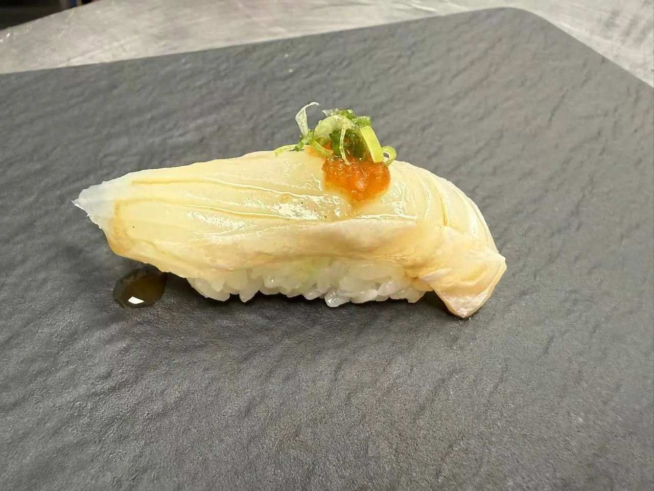 Silky butterfish nigiri with spicy sauce and scallions at Torii Japanese Inspired, a Japanese Restaurant in Katy