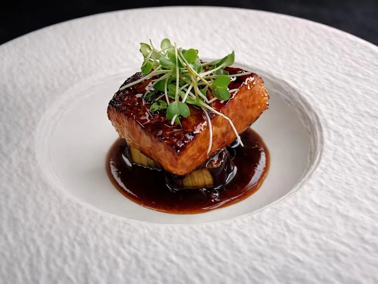 Pan-seared salmon with teriyaki glaze and microgreens at Torii Japanese Inspired, a Japanese Restaurant in Katy