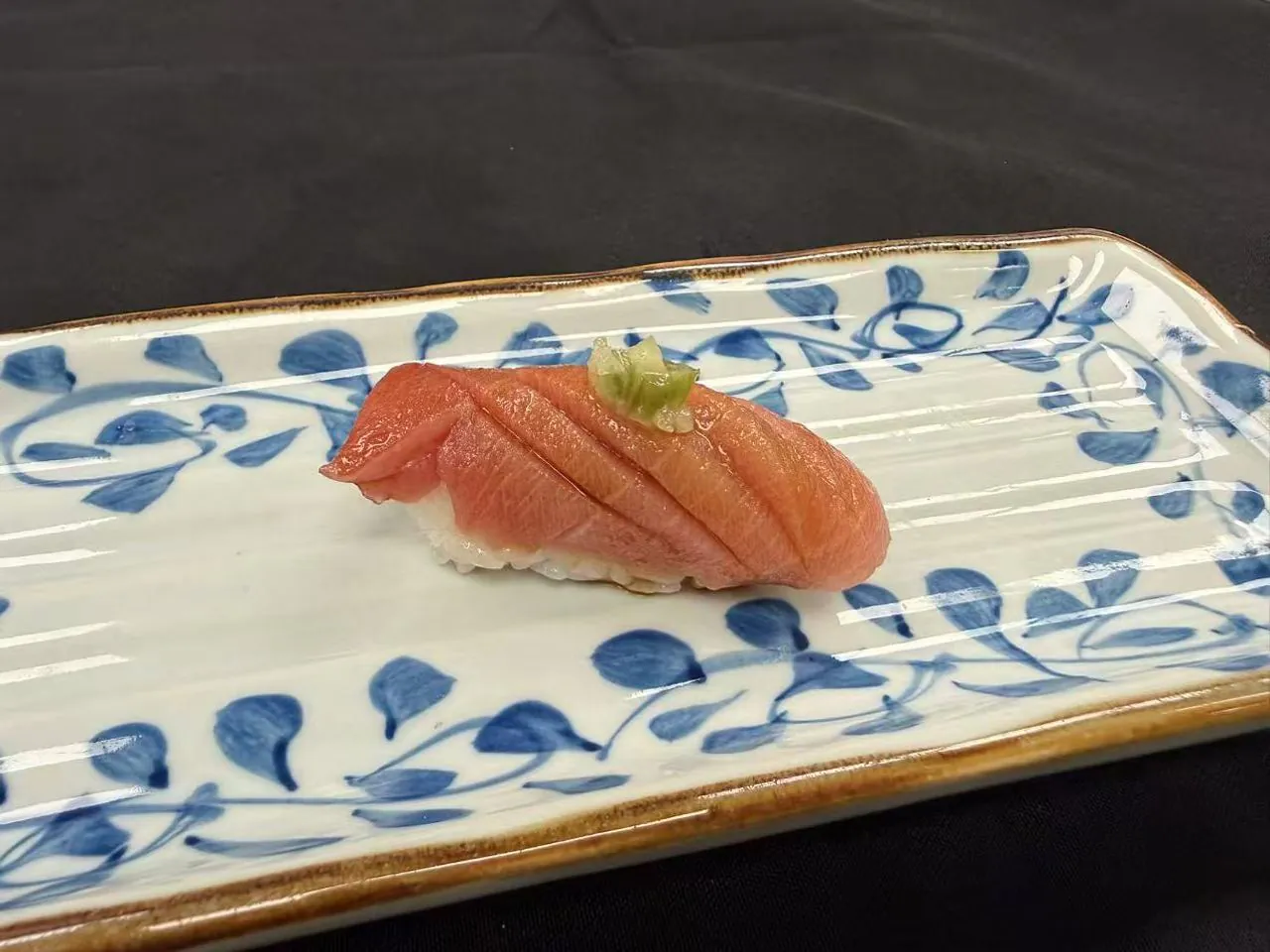 Fresh tuna nigiri with scallion garnish at Torii Japanese Inspired, a Japanese Restaurant in Katy